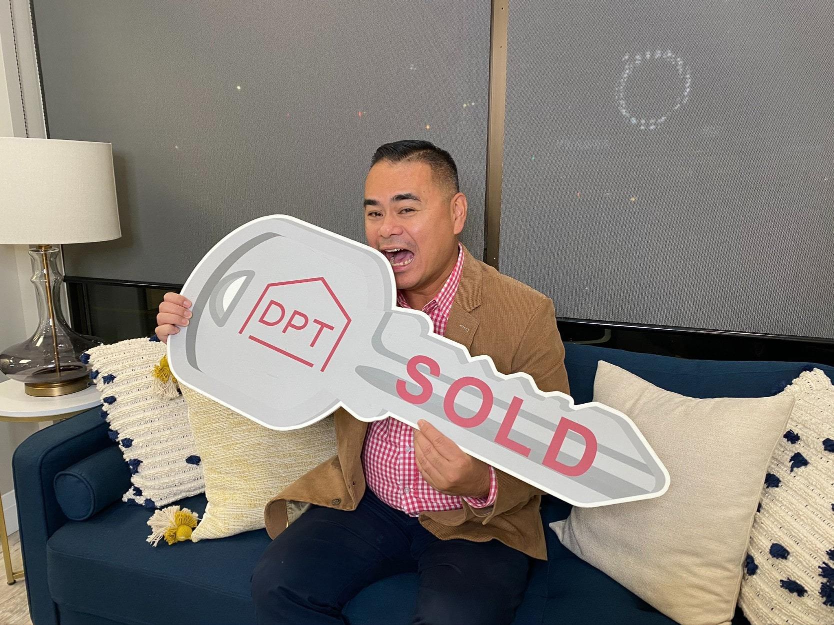 Glenn Kho realtor with a sold sign for a home for sale